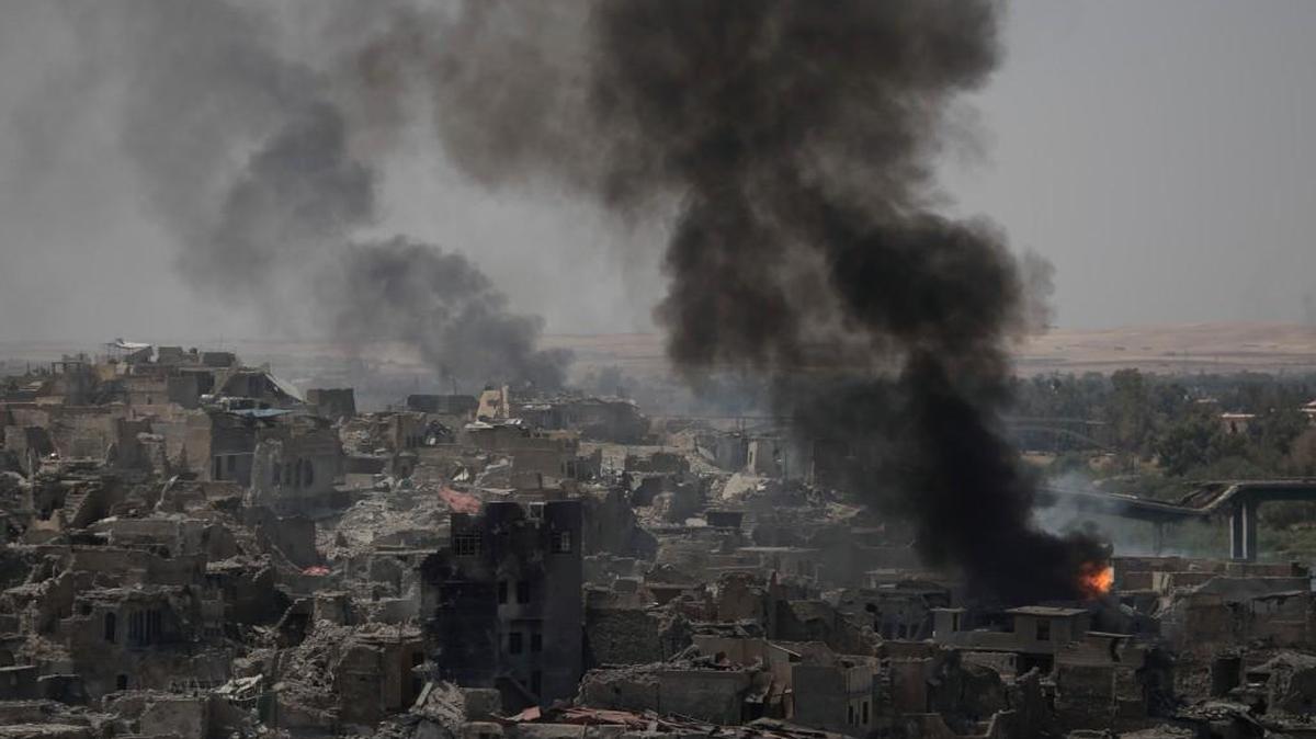 Smoke billows from Islamic State positions on the edge of the Old City a day after Iraq's prime minister declared "total victory" in Mosul, Iraq, on Tuesday.