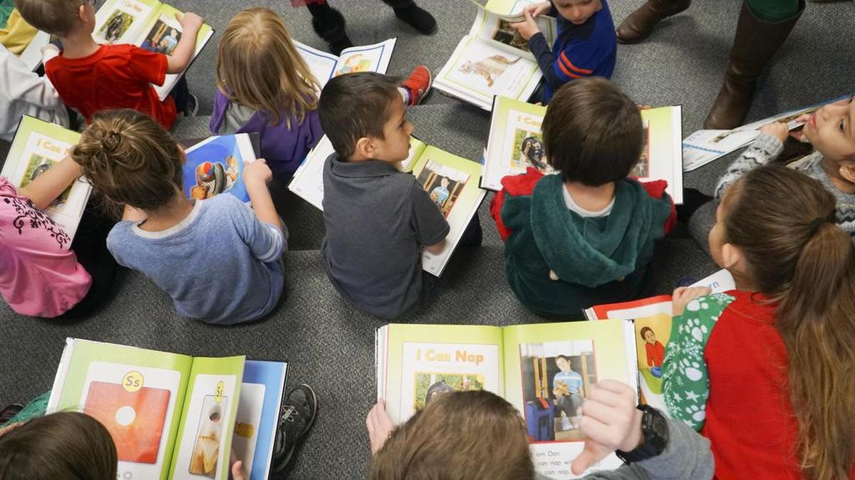 Students in Holly Morgan's kindergarten class at Peterson Elementary read together out of their textbook called Journeys in December 2017. Morgan been piloting a new reading program for the district.