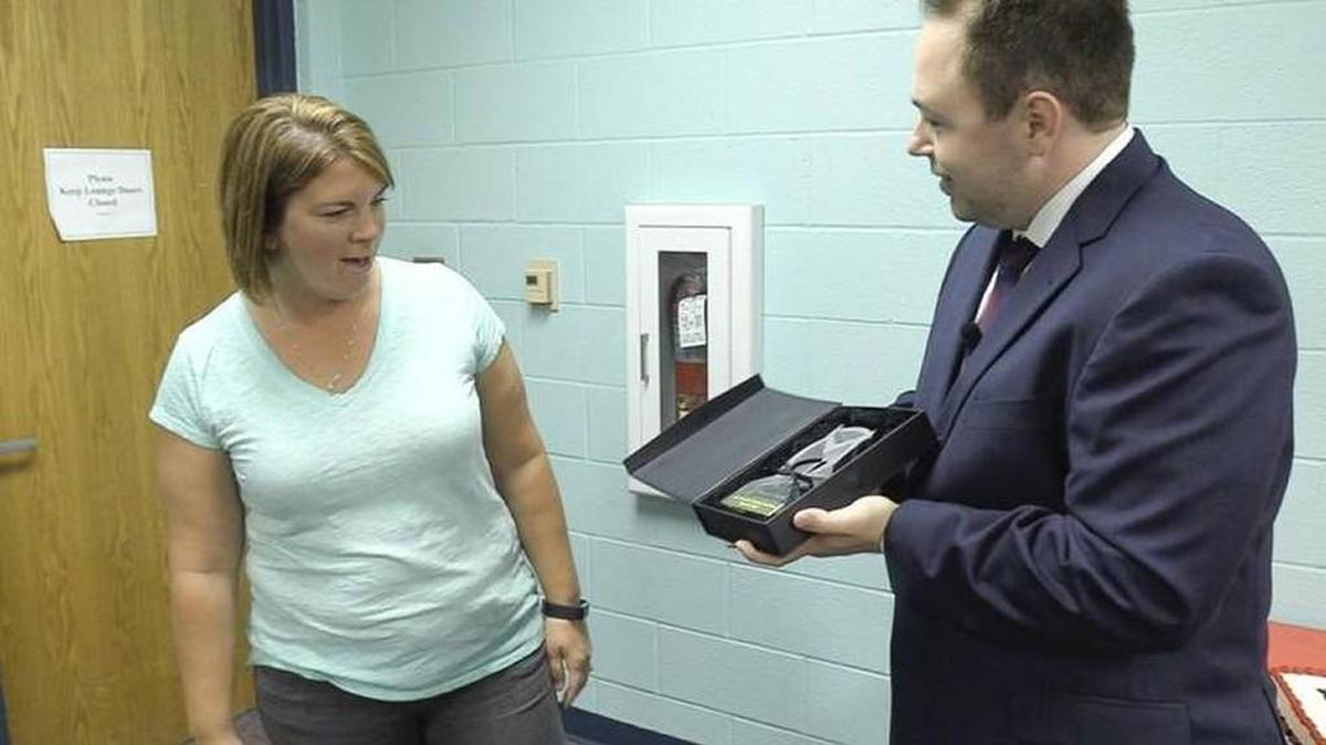 Crystal May is presented a crystal owl by Robert Curtis, assistant regional vice president of Horace Mann Insurance Co. May, a fourth-grade teacher at Pray-Woodman Elementary in Maize, is one of five national winners of the Horace Mann Award for Teaching Excellence.
