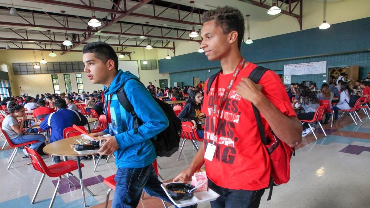 North High students Andres Garcia, left, and Zackery Freeman head back to class last November. This year, high school students in Wichita start the school day at 7:50 a.m., 40 minutes earlier than studies suggest secondary schools should begin.