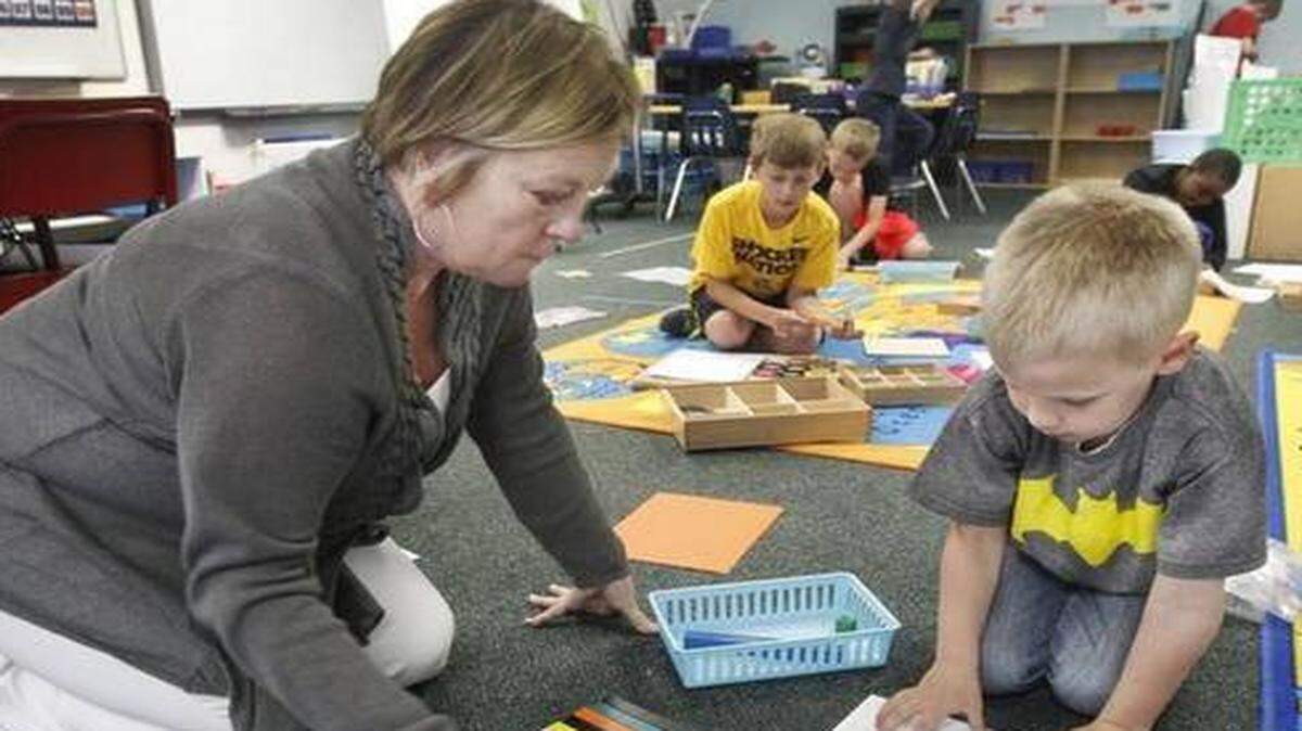 
Right Literacy Academy teacher Billie Vliet, left, works with 6-year-old Tommy Barbour on a project at the school. (April 10, 2015)
