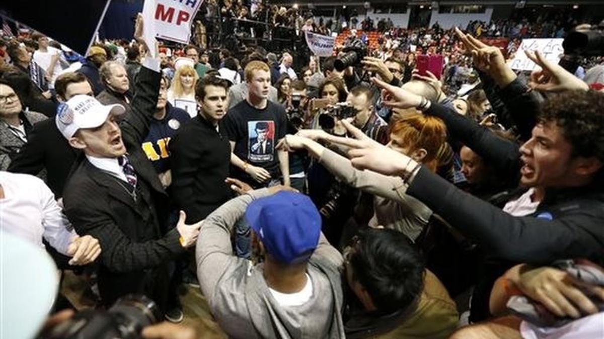 Donald Trump supporters, left, face off with protesters after a rally in Chicago was canceled because of security concerns.