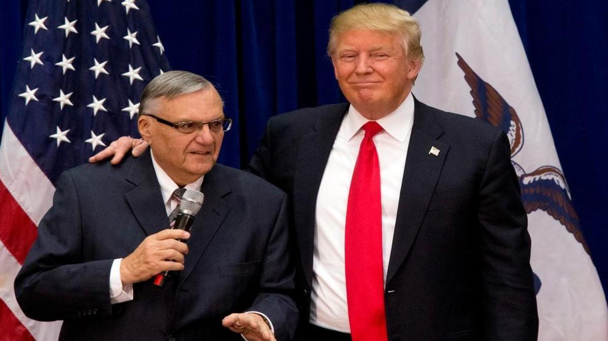 Presidential candidate Donald Trump puts his arm around former Arizona sheriff Joe Arpaio during a January 2016 campaign event in Marshalltown, Iowa. Trump pardoned Arpaio on Friday night, ending his conviction for intentionally disobeying a judge’s order in an immigration case.