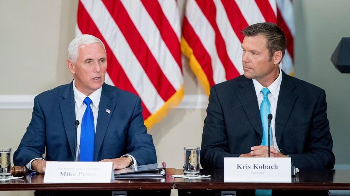 Kansas secretary of state Kris Kobach, right, listens to Vice President Mike Pense during the first meeting of the Presidential Advisory Commission on Election Integrity last July.