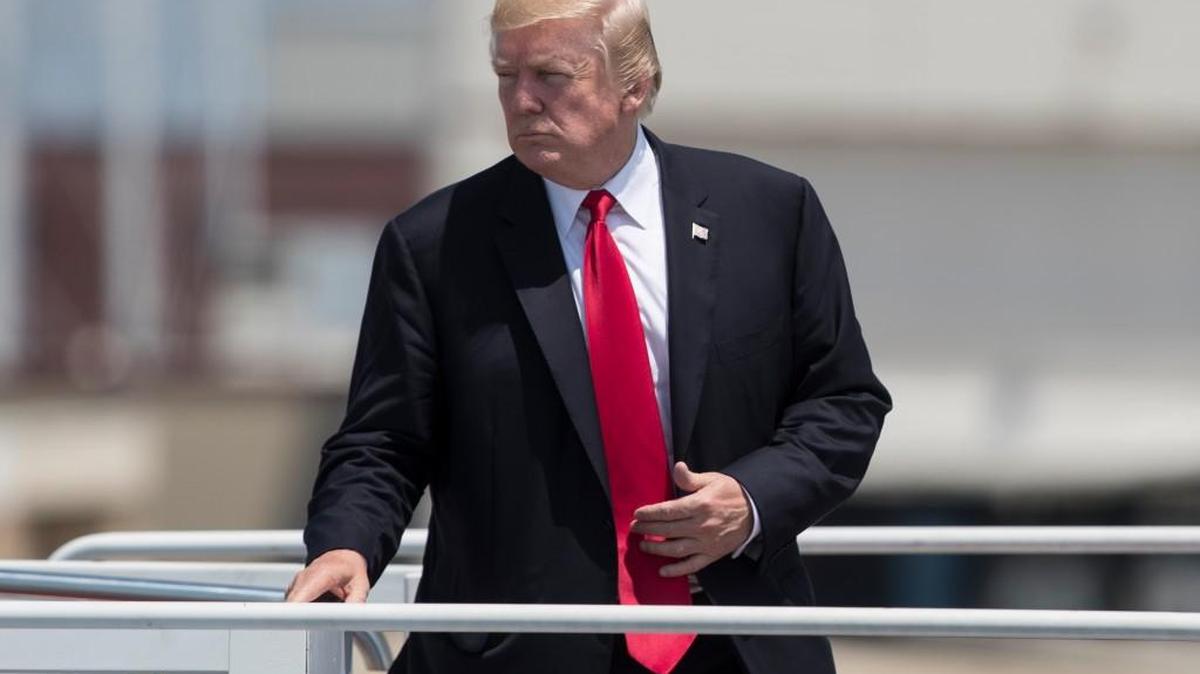 President Donald Trump turns as he boards Air Force One in Naval Air Station Norfolk, in Norfolk, Va., on Saturday.