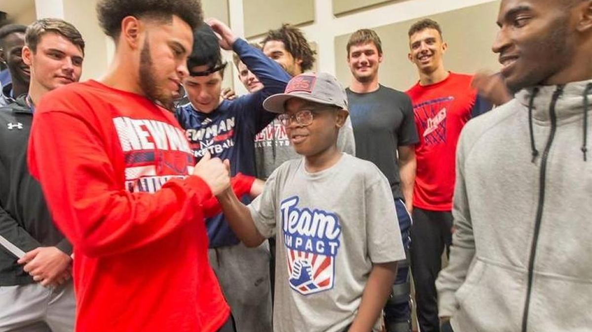 Julian Randle is welcome to the Newman Jets basketball team by teammates last week.