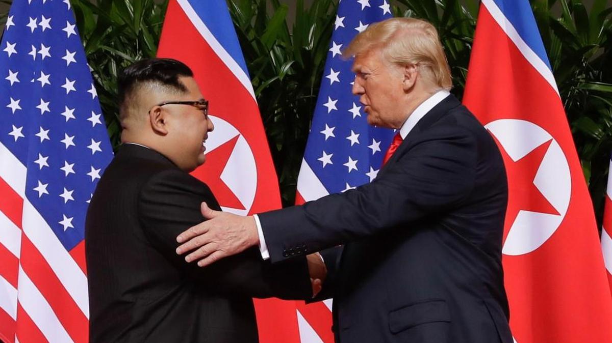 FILE - In this Tuesday, June 12, 2018 file photo, U. S. President Donald Trump shakes hands with North Korea leader Kim Jong Un at the Capella resort on Sentosa Island in Singapore. President Donald Trump has already met with Russian President Vladimir Putin twice, but he is eager to recreate in Finland the heady experience that he had last month with North Korean leader Kim Jong Un. That Singapore summit became a mass media event complete with powerful presidential images. (AP Photo/Evan Vucci, File)