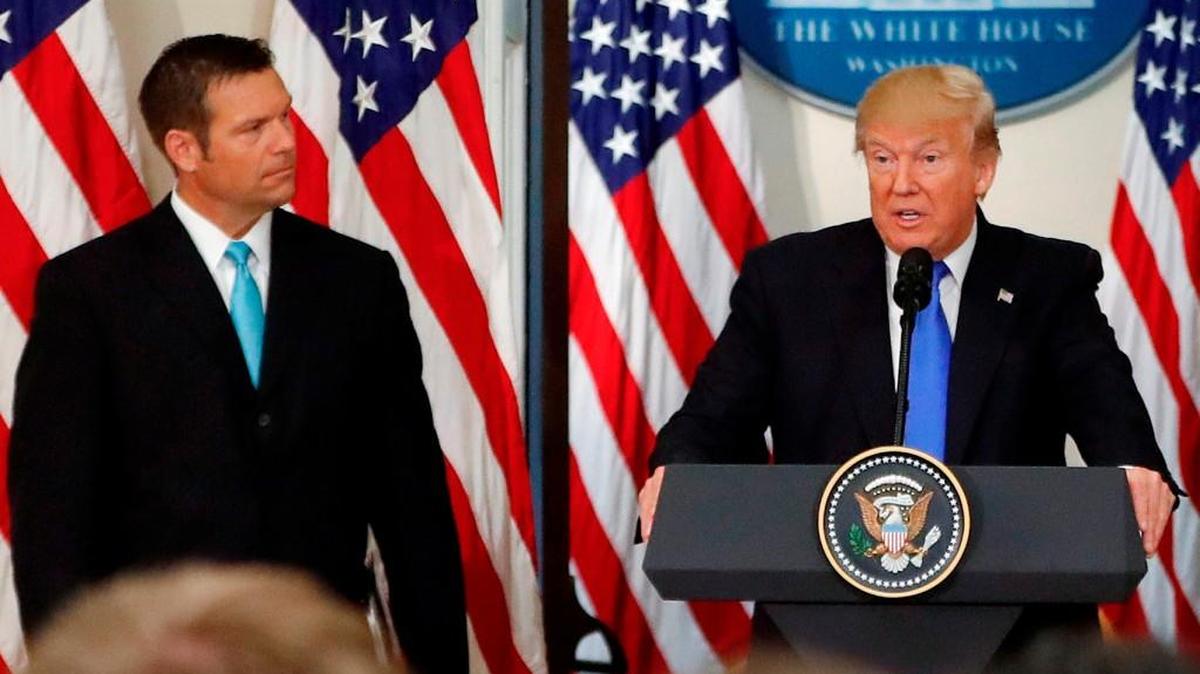 President Donald Trump, with Kansas Secretary of State Kris Kobach, speaks at a meeting of the Presidential Advisory Commission on Election Integrity, Wednesday, July 19, 2017, in the Eisenhower Executive Office Building on the White House complex in Washington.
