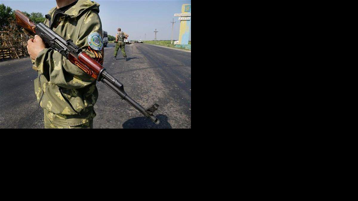 
Pro-Russian rebels stand at a security post on the outskirts of Donetsk in eastern Ukraine. 
