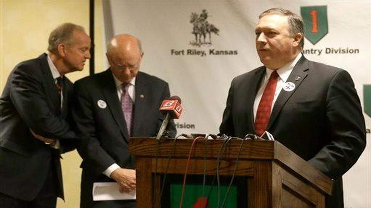 
Rep. Mike Pompeo, R-Kan., right, speaks to the media before a town hall meeting Monday regarding the future of Fort Riley Kansas Senators Jerry Moran, left, and Pat Roberts talk in the background.
