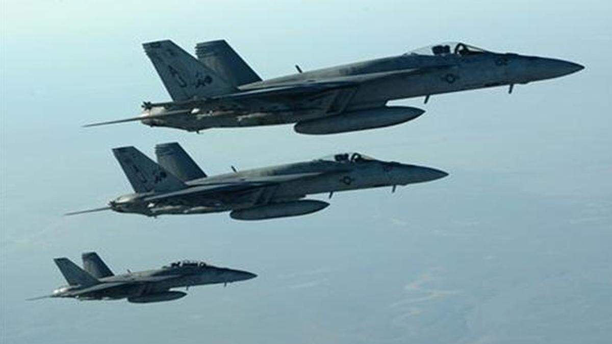 
U.S. Navy F-18E Super Hornets leave after receiving fuel from a KC-135 Stratotanker over northern Iraq, as part of U.S.-led coalition airstrikes on the Islamic State group in Syria.
