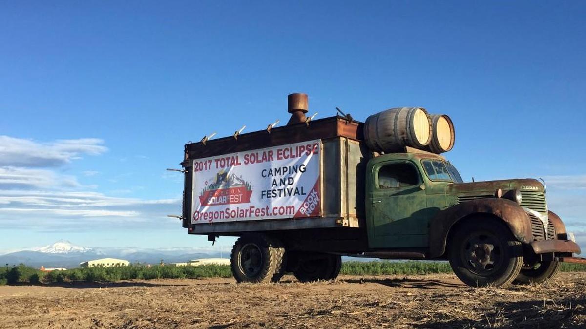 An advertisement for a central Oregon festival built around Monday’s total solar eclipse sits alongside a busy road leading into Madras, Ore. Traffic is already a headache in central Oregon as thousands of people arrive before Monday's total solar eclipse.