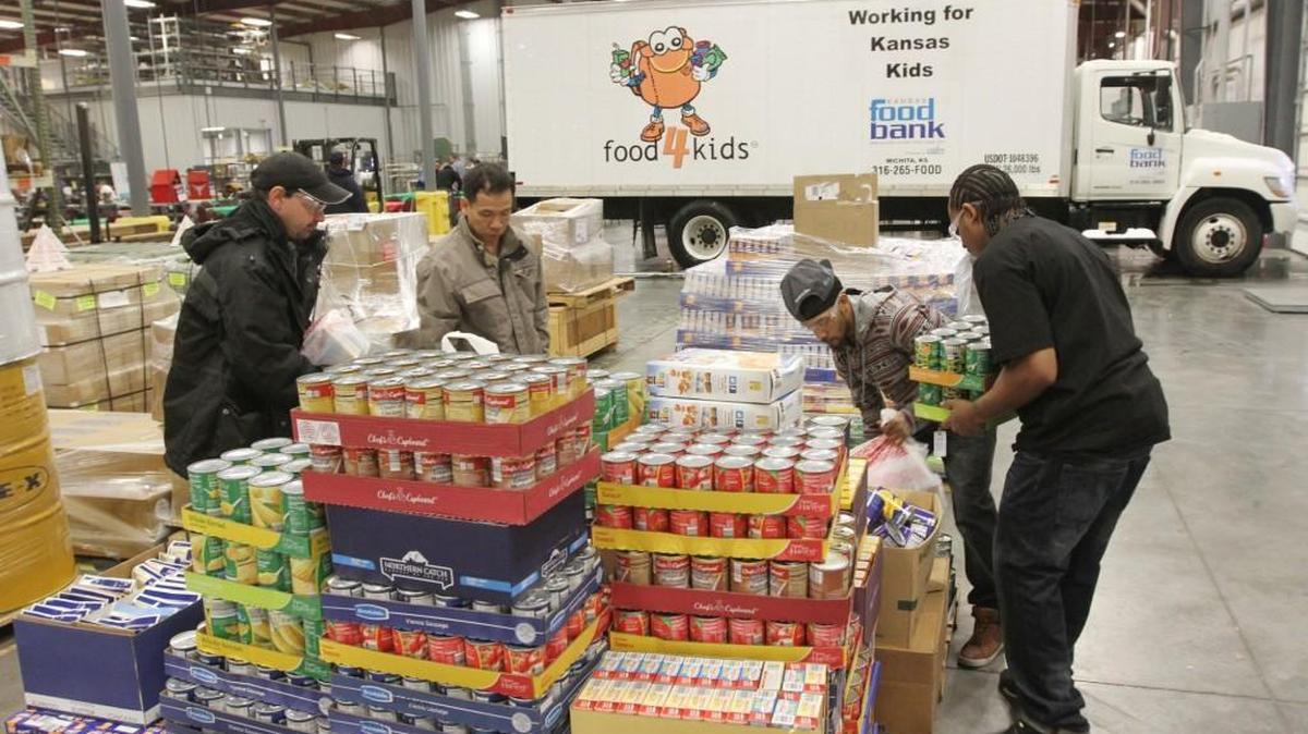 Employees of Leading Technology Composites organize donated food before it's loaded onto a Kansas Food Bank truck in 2013.