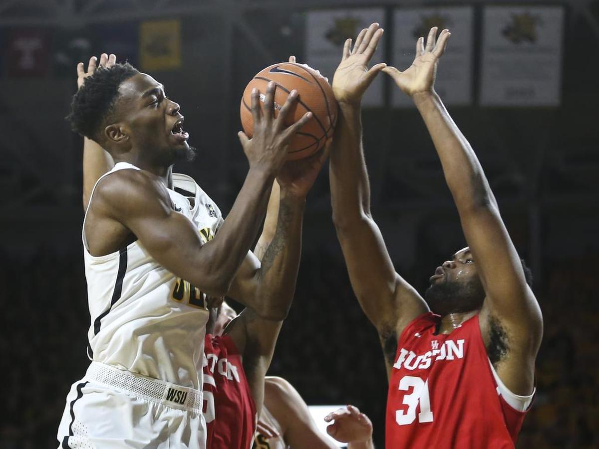 Wichita State forward Markis McDuffie goes to the basket against Houston center Valentine Sangoyomi during the second half of their game at Koch Arena on Thursday night.