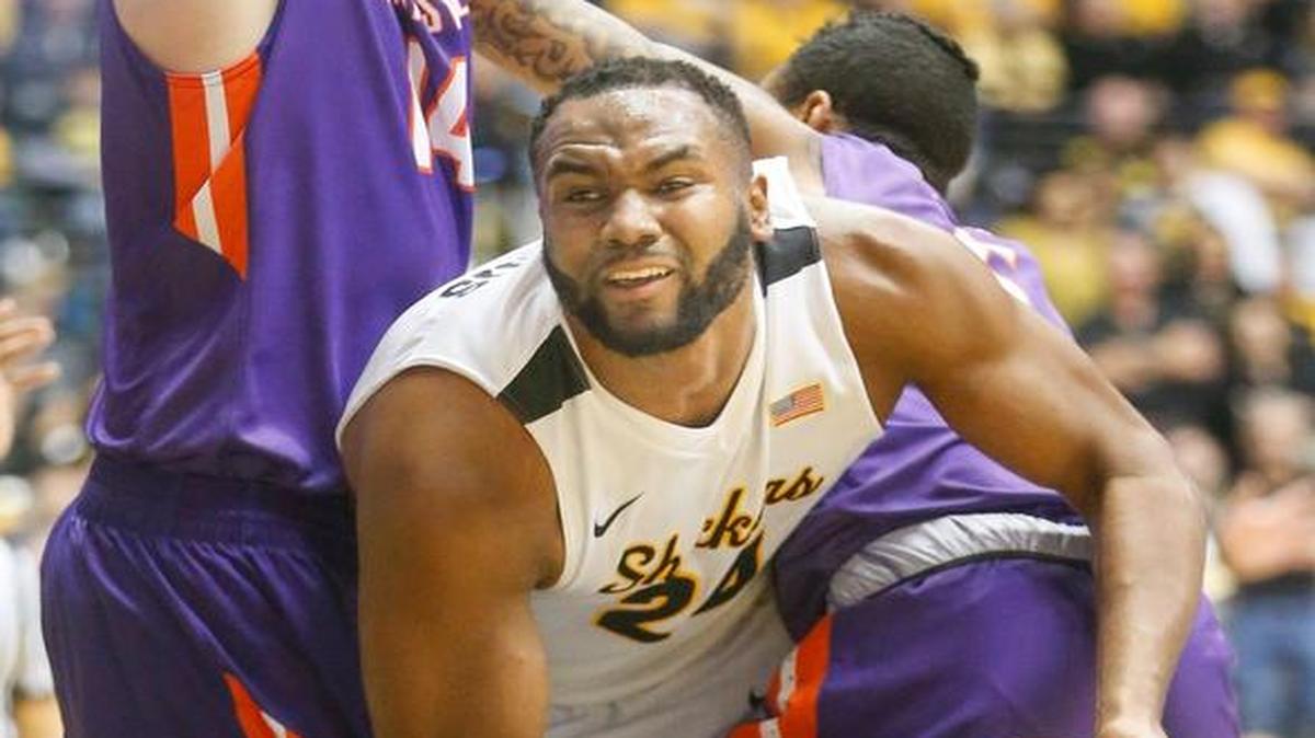 Wichita State center Shaquille Morris tries to squeeze through Evansville’s Sergej Vucetic, left, and forward Solomon Hainna during the first half of their game Tuesday at Koch Arena.