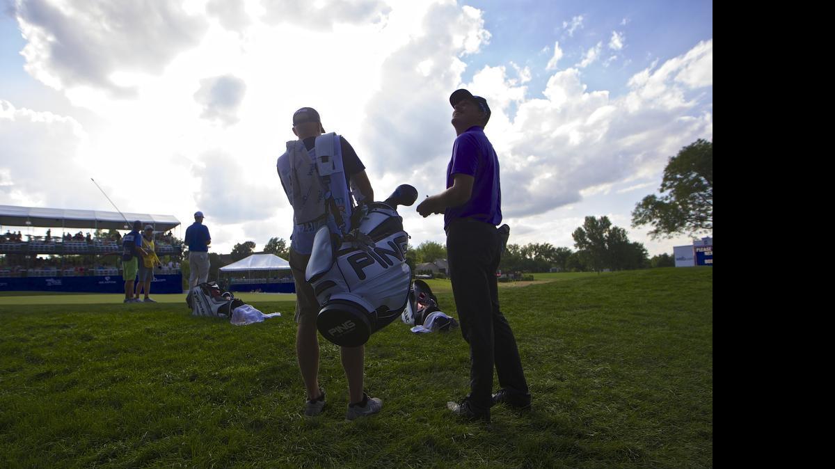 
Joel Dahmen turns to the crowd in the stands surrounding the green on No. 17 as fans called out for free souvenirs in the second round of the Air Capital Classic at Crestview Country Club on Friday afternoon. 
