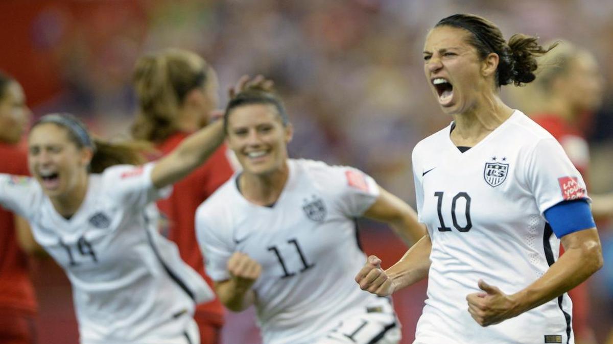 
Carli Lloyd (10) celebrates with U.S. teammates Ali Krieger (11) and Morgan Brian after Lloyd scored the game’s first goal on a penalty kick against Germany during the second half Tuesday Montreal. 

