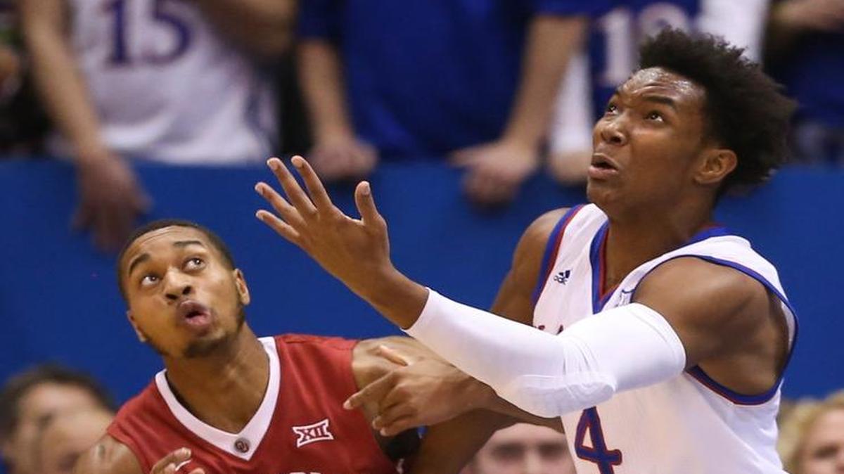 Kansas guard Devonte’ Graham chases a rebound against Oklahoma guard Isaiah Cousins during the first half Monday at Allen Fieldhouse.