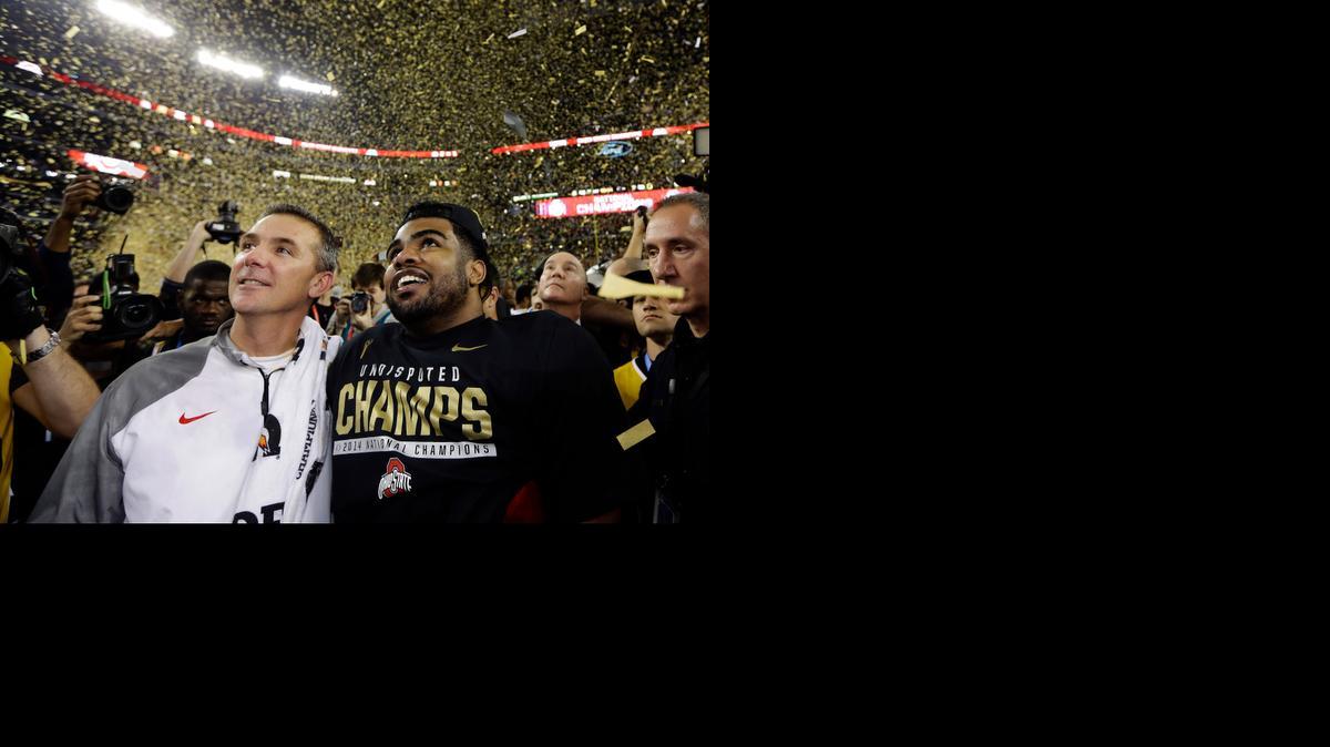 Ohio State head coach Urban Meyer and Exekiel Elliott celebrate after winning the College Football Playoff championship game against Oregon on Monday in Arlington, Texas. Ohio State won 42-20 for its first national title since 2002.