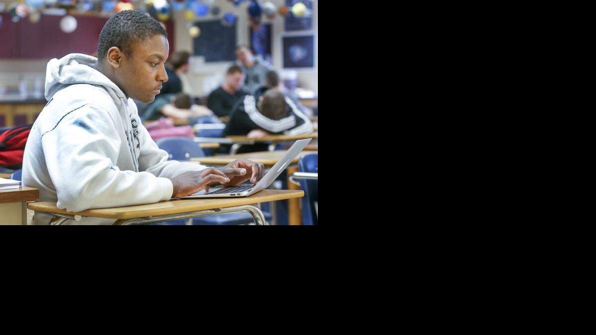 
Derby senior wrestler Armoni Coppins does some schoolwork before practice at Derby High on Wednesday. 
