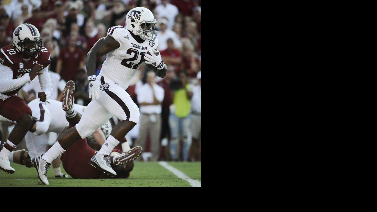 
Texas A&M running back Tra Carson (21) runs against South Carolina during the first half last Thursday. Texas A&M won 52-28. 
