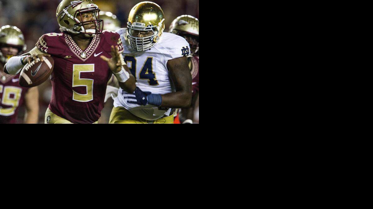 
Notre Dame lineman Jarron Jones, right, chases Florida State quarterback Jameis Winson. (Oct. 18, 2014)
