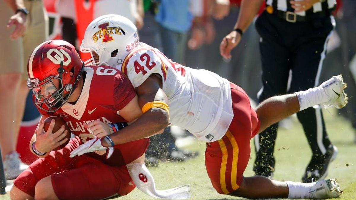Oklahoma quarterback Baker Mayfield gets tackled by Iowa State linebacker Marcel Spears Jr. during an NCAA college football game in Norman, Okla., Saturday, Oct. 7, 2017. Iowa State defeated No. 3 Oklahoma 38-31. (Ian Maule/Tulsa World via AP)