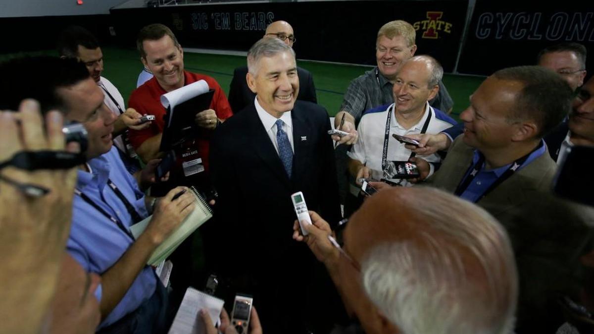 Big 12 commissioner Bob Bowlsby smiles while surrounded by reporters during the Big 12 media day at the Dallas Cowboys practice facilities in Frisco, Texas, Monday, July 17, 2017. (AP Photo/LM Otero)