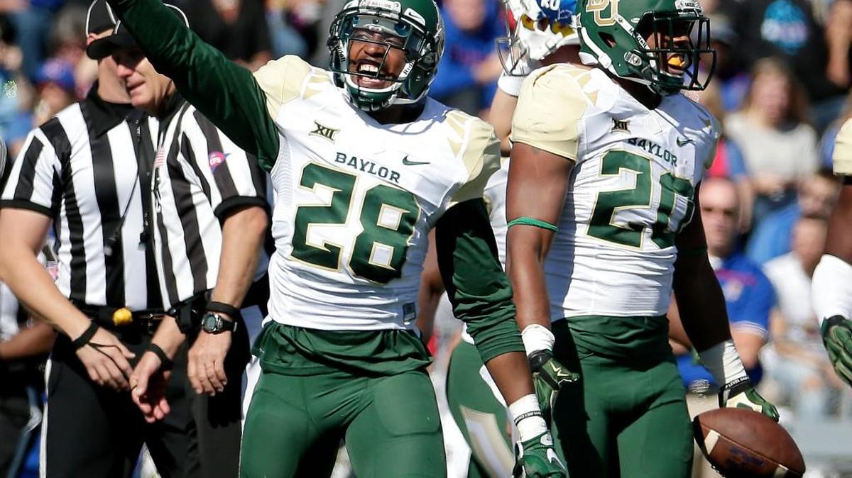 
Baylor safety Orion Stewart (28) and linebacker Aiavion Edwards (20) celebrate during a win at Kansas. (AP Photo/Charlie Riedel)

