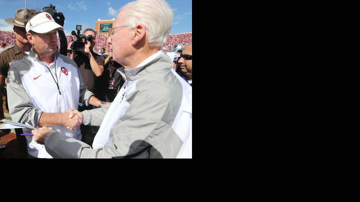 
K-State coach Bill Snyder and Oklahoma coach Bob Stoops meet at midfield after the Wildcats defeated the Sooners on Saturday in Norman.
