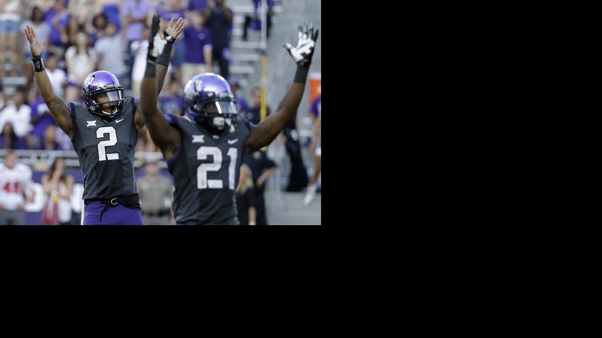 
TCU quarterback Trevone Boykin and running back Kyle Hicks celebrate after a touchdown against Texas Tech. TCU won 82-27. (Oct. 25, 2014)
