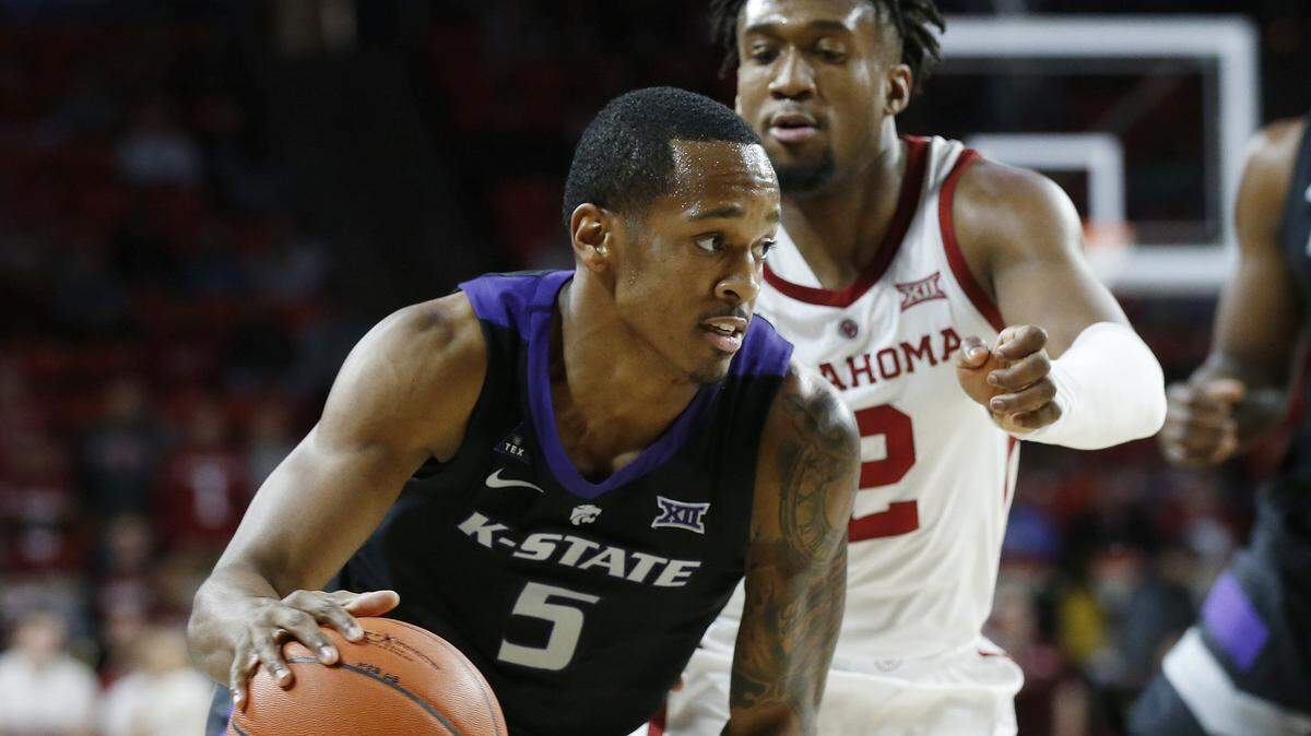 Kansas State guard Barry Brown drives past Oklahoma guard Aaron Calixte during the first half of Wednesday’s game in Norman, Okla.