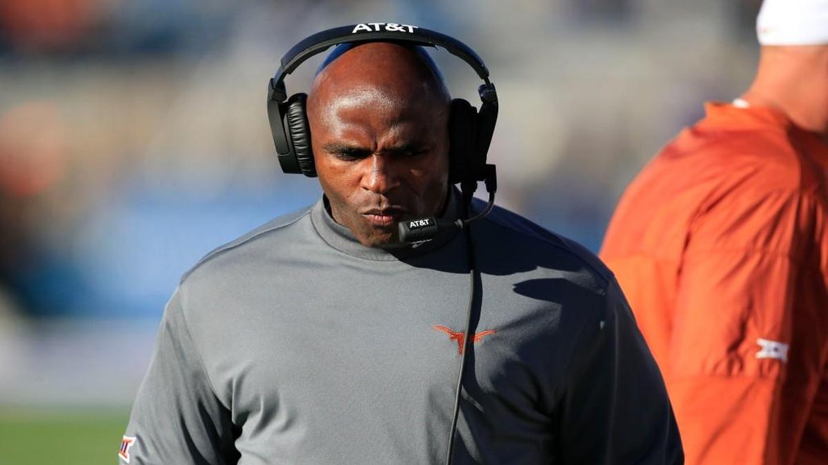 Texas coach Charlie Strong walks the sideline during the first half of an NCAA college football game against Kansas in Lawrence, Kan., Saturday, Nov. 19, 2016. (AP Photo/Orlin Wagner)