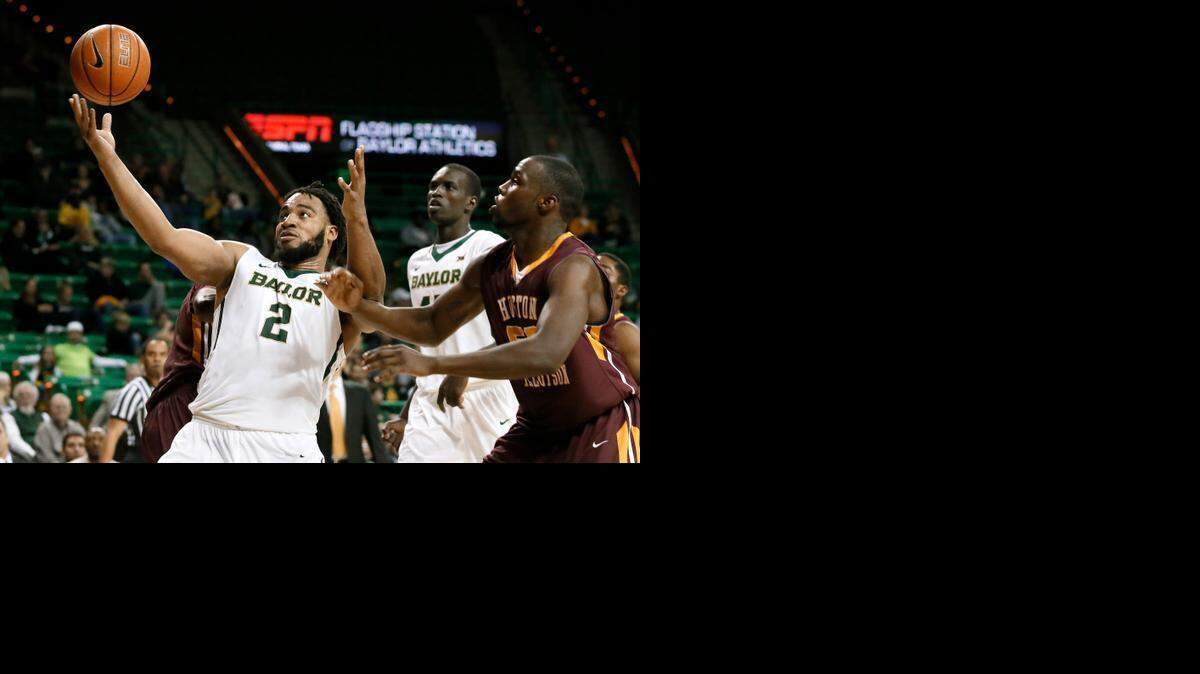 
Baylor's Rico Gathers grabs an offensive rebound in front of Huston-Tillotson’s Chris Edwards, right, in the second half Wednesdsay in Waco, Texas.

