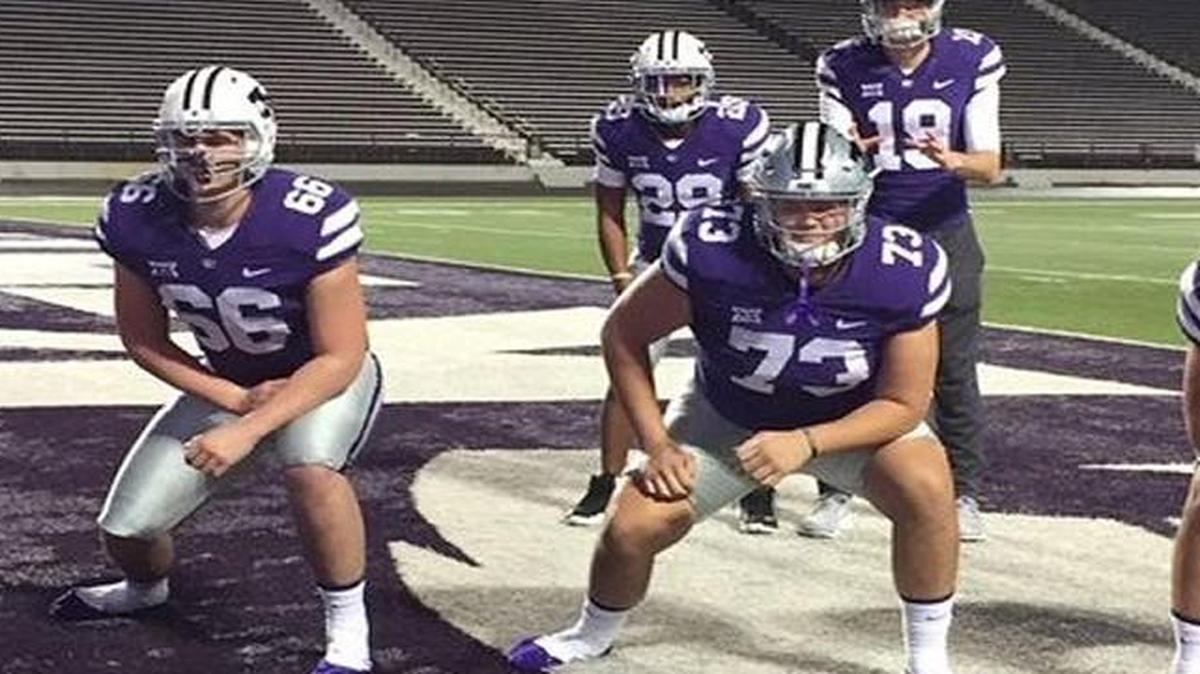 Harrison Creed (center, No. 73) poses with Aidan Mills (left, No. 66) and other Kansas State football recruits on an official visit.