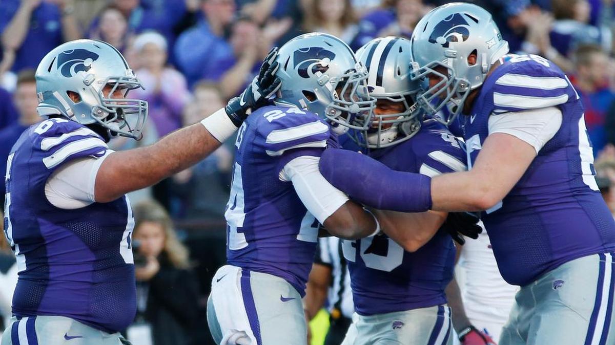 
K-State players celebrate withe running back Charles Jones after he scored a touchdown against Kansas last season.
