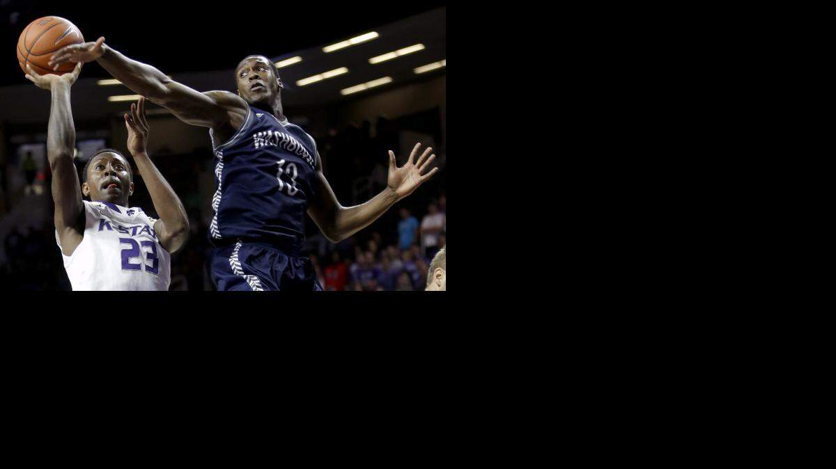 
Kansas State's Nigel Johnson (23) shoots under pressure from Washburn's Chris Deanes during the first half of an NCAA college exhibition basketball game Sunday, Nov. 9, 2014, in Manhattan, Kan. (AP Photo/Charlie Riedel) 

