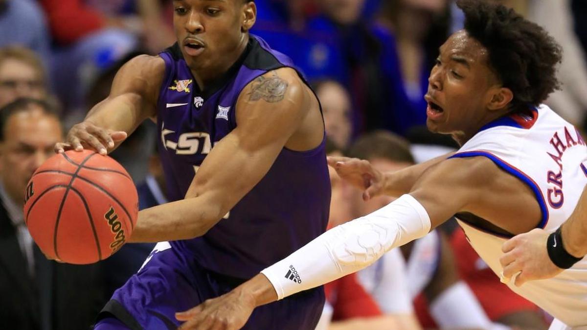 Kansas State guard Barry Brown is covered by Kansas guard Devonte' Graham in Lawrence, Kan., Tuesday, Jan. 3, 2017. (AP Photo/Orlin Wagner)