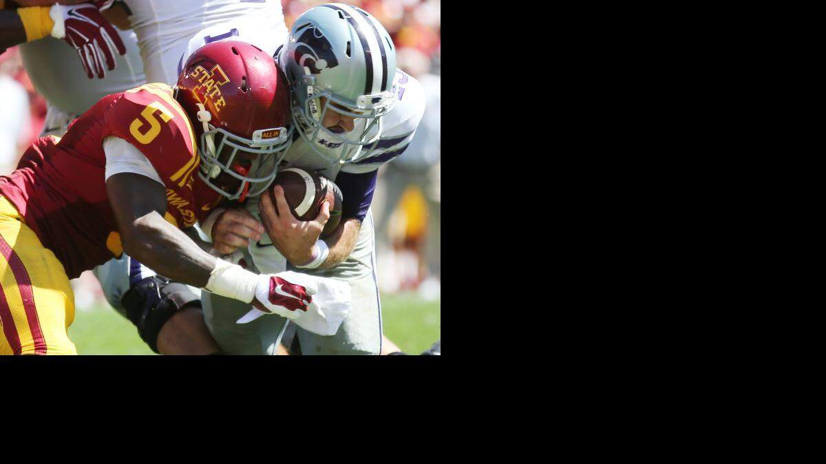 Kansas State quarterback Jake Waters collides helmet-to-helmet with Iowa State defensive back Kamari Cotton-Moya just short of the goal line as Waters attempted a two-point conversion during the fourth quarter of Saturday’s game in Ames, Iowa.