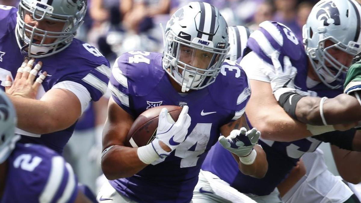 K-State running back Alex Barnes runs through a hole during the Wildcats’ win over Charlotte on Sept. 9 in Manhattan.