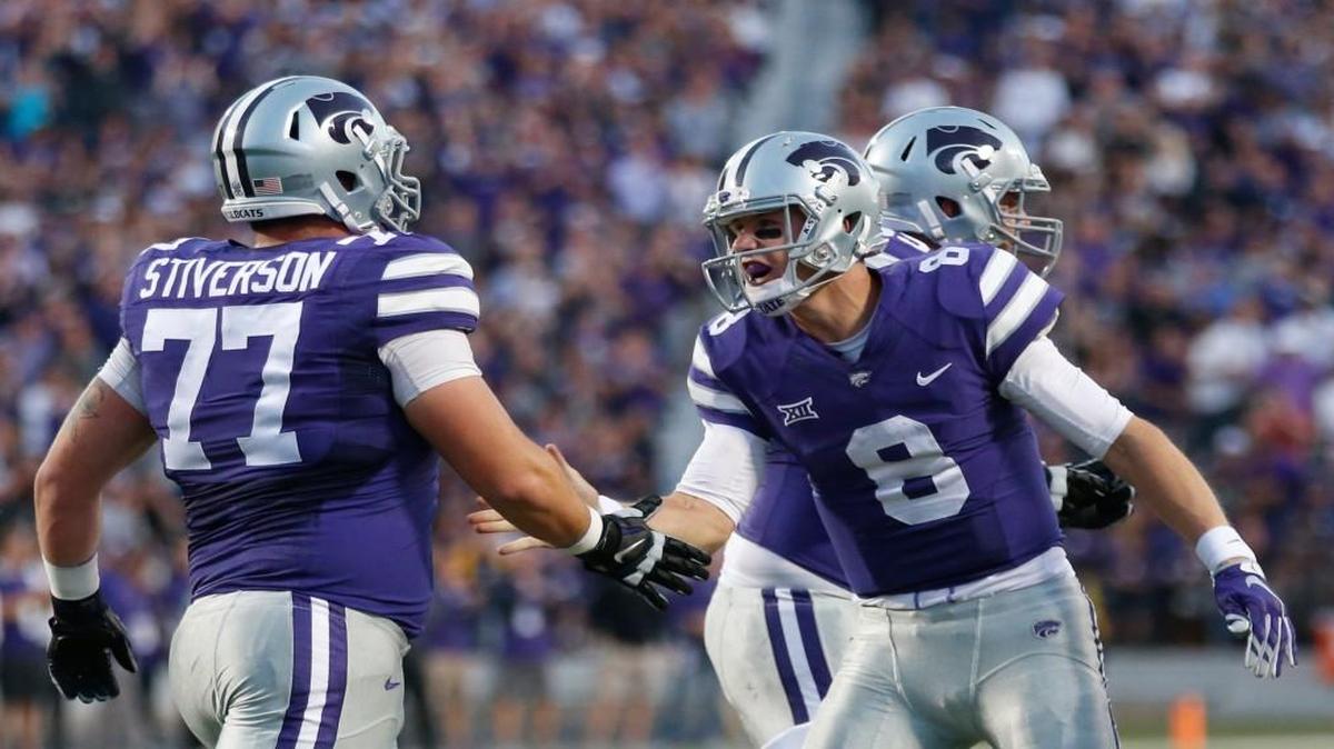 K-State quarterback Joe Hubener celebrates with K-State offensive lineman Boston Stiverson after Hubener scored a touchdown earlier this season.
