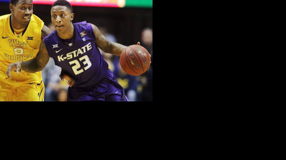 
Kansas State guard Nigel Johnson (23) drives up court while being defended by West Virginia guard Juwan Staten (3) during the first half.
