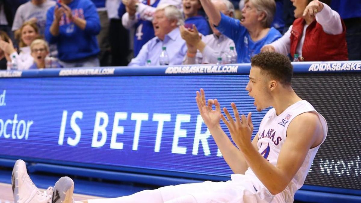 Kansas guard Brannen Greene celebrates a three-pointer and a foul with less than 10 seconds to go in the first half against Kansas State at Allen Fieldhouse on Wednesday night. He dunked at the end of the game with no K-State player defending, a move KU coach Bill Self called “classless.”