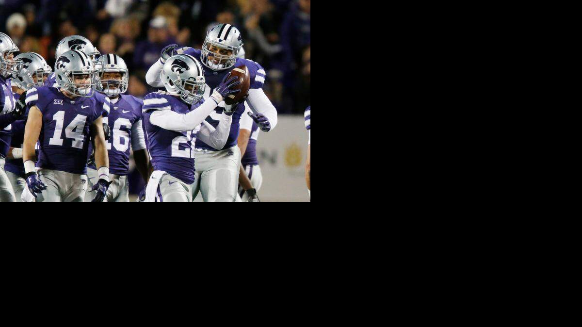 
K-State defensive back Dante Barnett (22) celebrates after intercepting a pass against Oklahoma State on Saturday in Manhattan.
