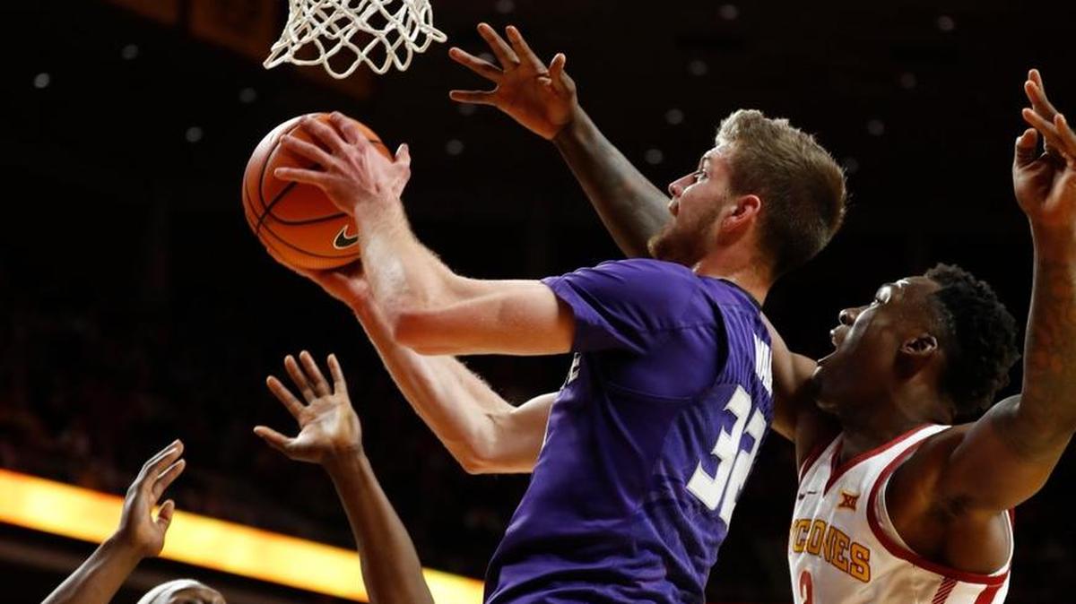 Kansas State forward Dean Wade drives to the basket between Iowa State defenders Solomon Young, left, and Cameron Lard, right, during the first half Friday in Ames, Iowa.