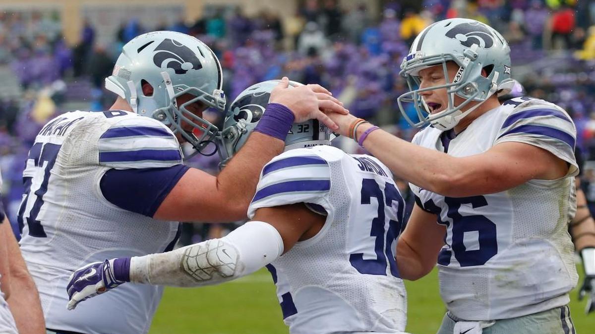 K-State offensive lineman Reid Najvar, left, congratulations Justin Silmon after a touchdown Dec. 3 at TCU.