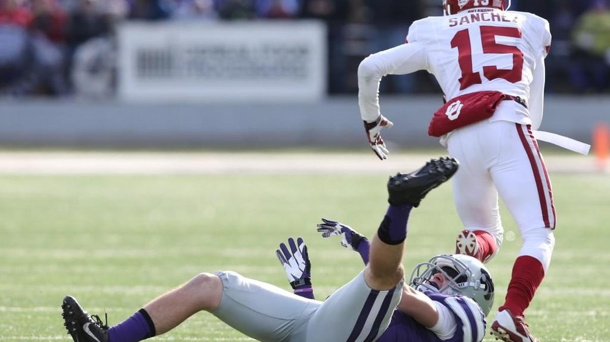 
Oklahoma defensive back Zack Sanchez intercepts a Jake Waters pass and leaves intended receiver K-State wide receiver Curry Sexton in his wake as he runs for a touchdown during the Sooners’ November 2013 victory in Manhattan.
