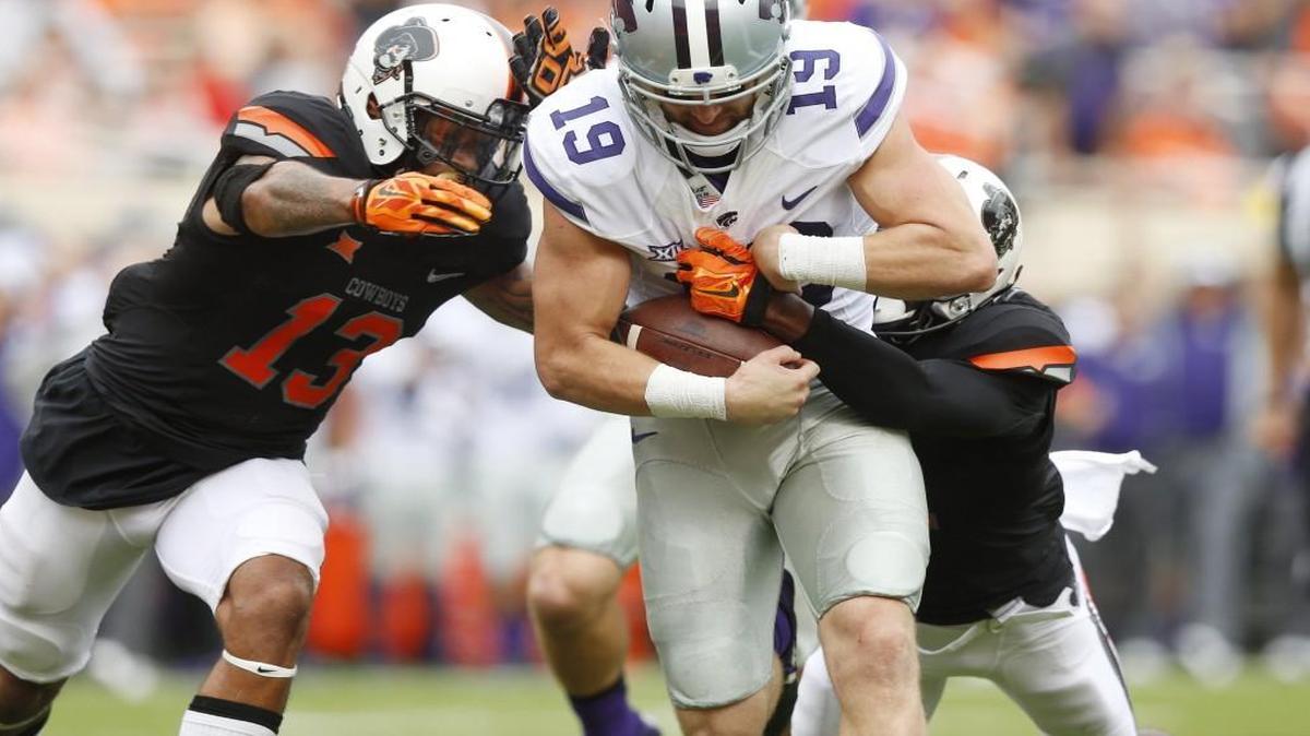 
Kansas State’s Kody Cook runs through the Oklahoma State defense during the first quarter Saturday in Stillwater. Cook, a reserve wide receiver, played quarterback after starter Joe Hubener was injured in the opening minutes. 
