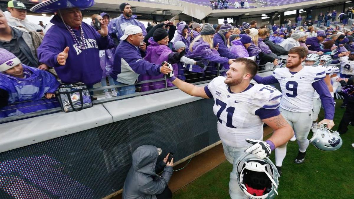 K-State offensive lineman Dalton Risner is congratulated by fans after the Wildcats defeated TCU 30-6 in December.