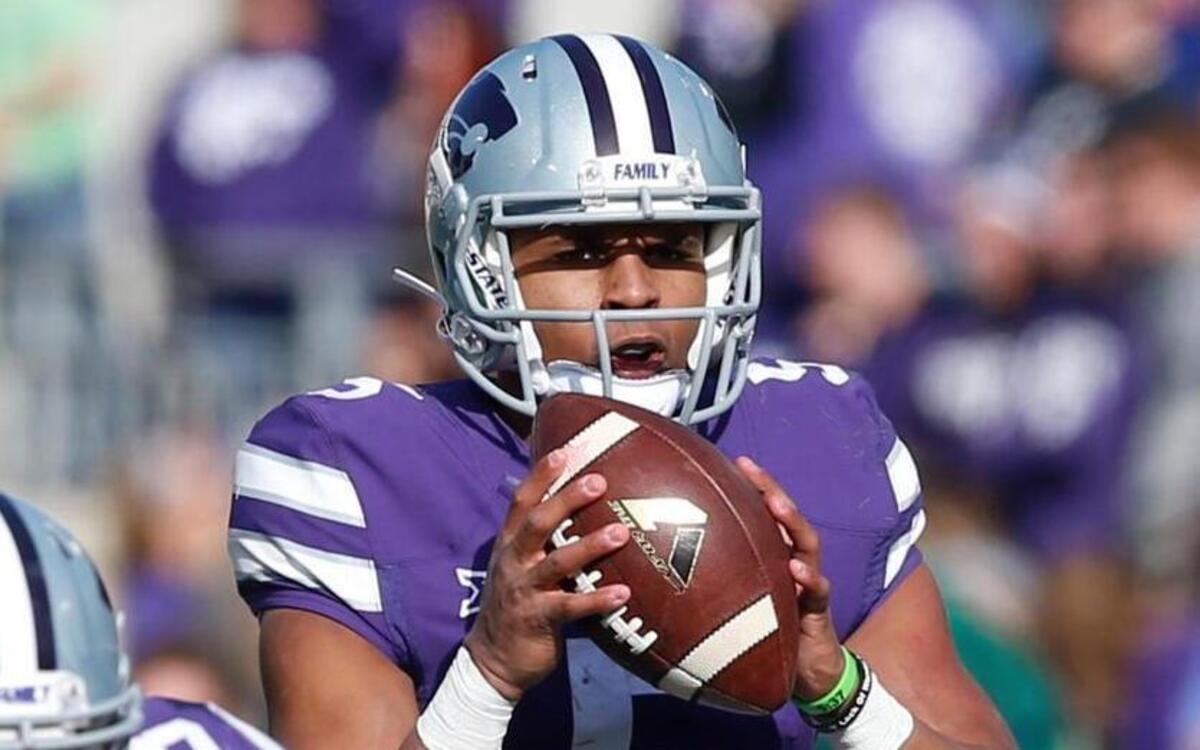 K-State quarterback Alex Delton takes a snap against Kansas during last season’s game in Manhattan.